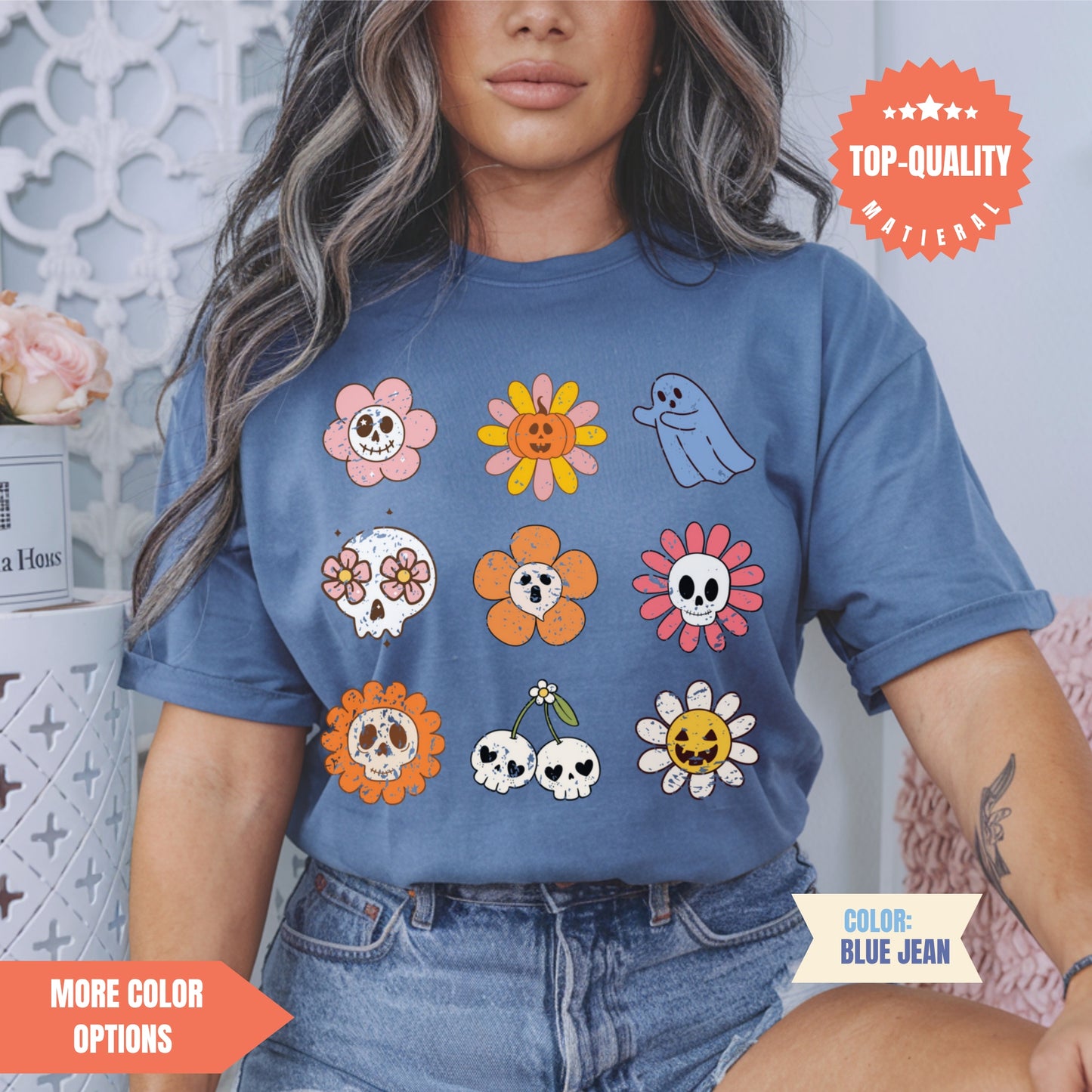 a woman wearing a t - shirt with skulls and flowers on it