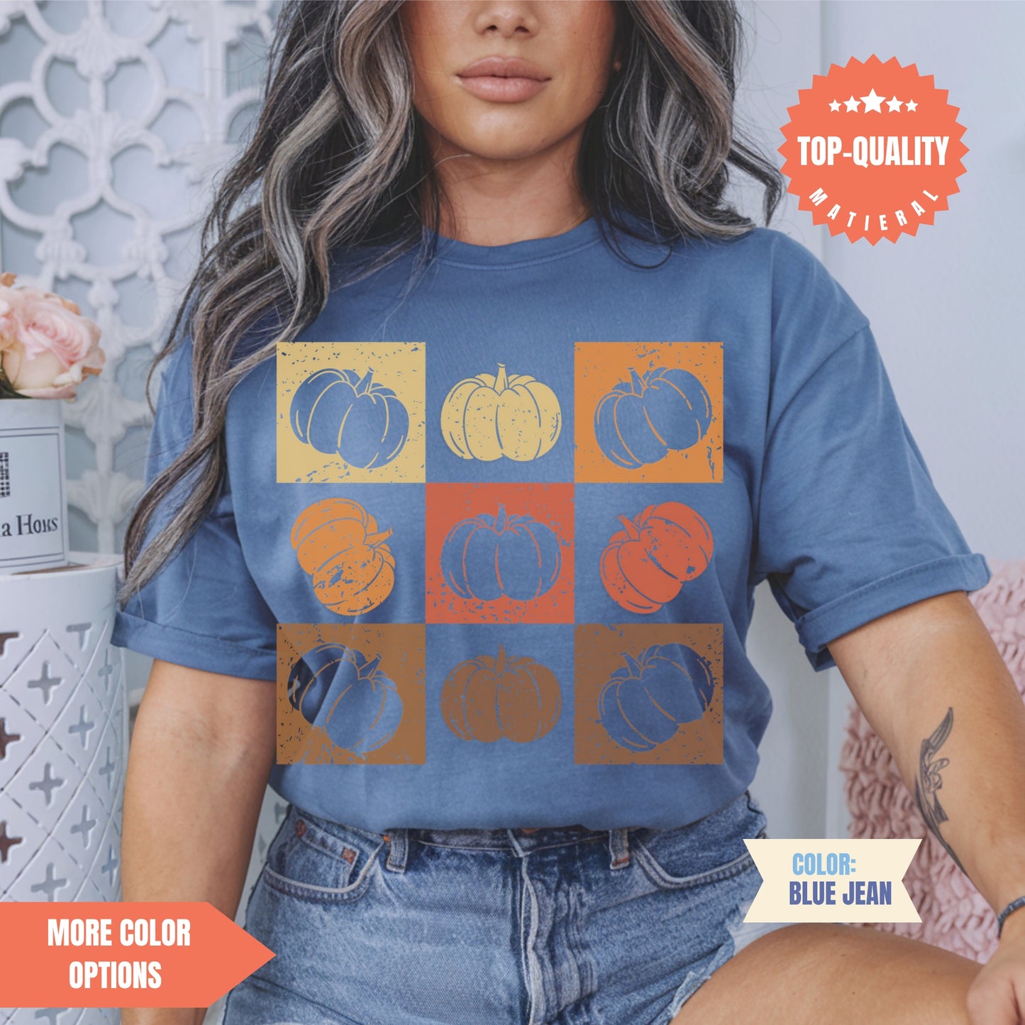 a woman wearing a blue shirt with pumpkins on it