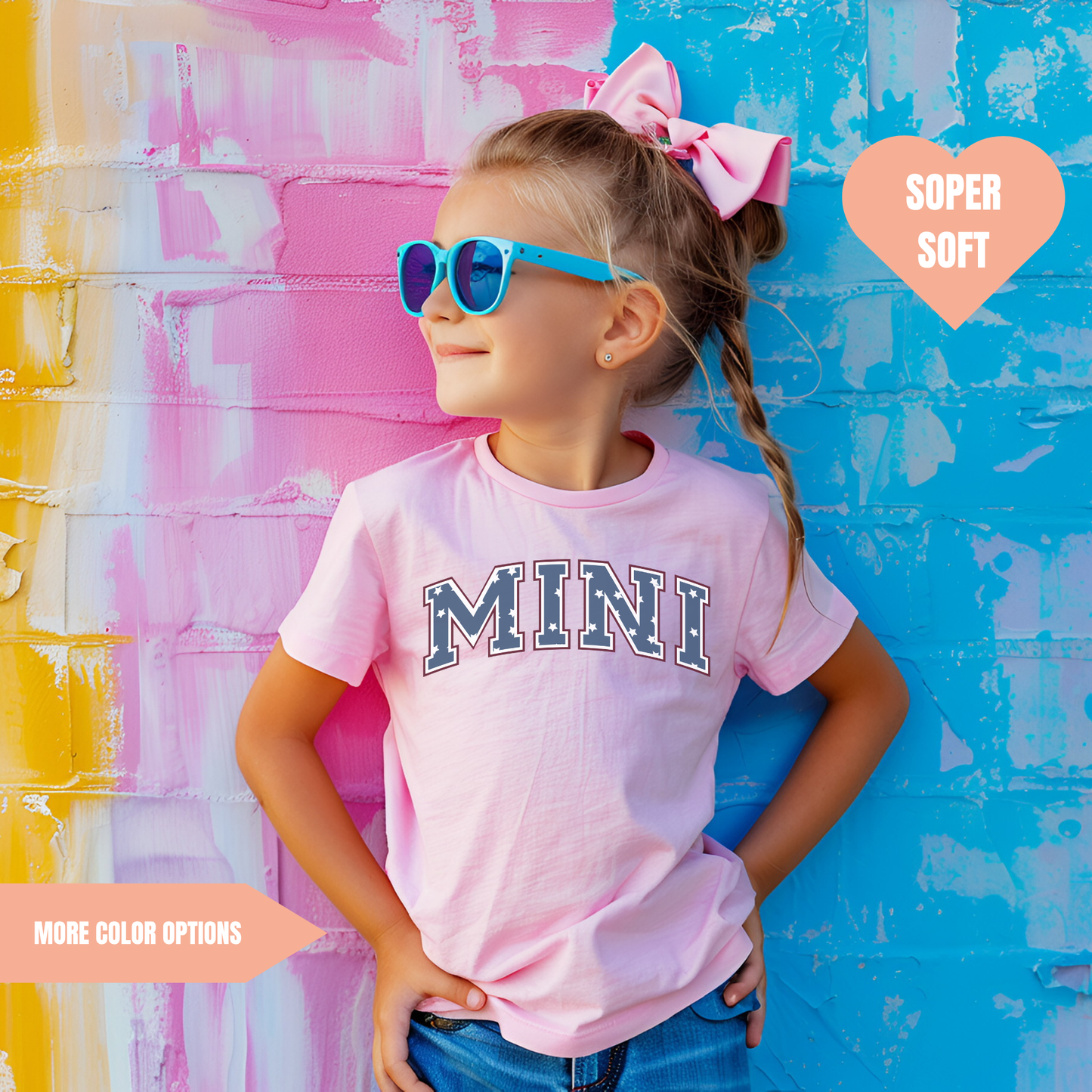 a little girl wearing a pink shirt and sunglasses
