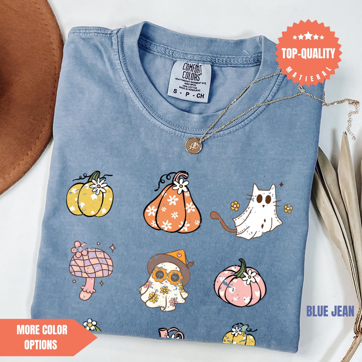 a blue t - shirt with a picture of pumpkins and cats on it