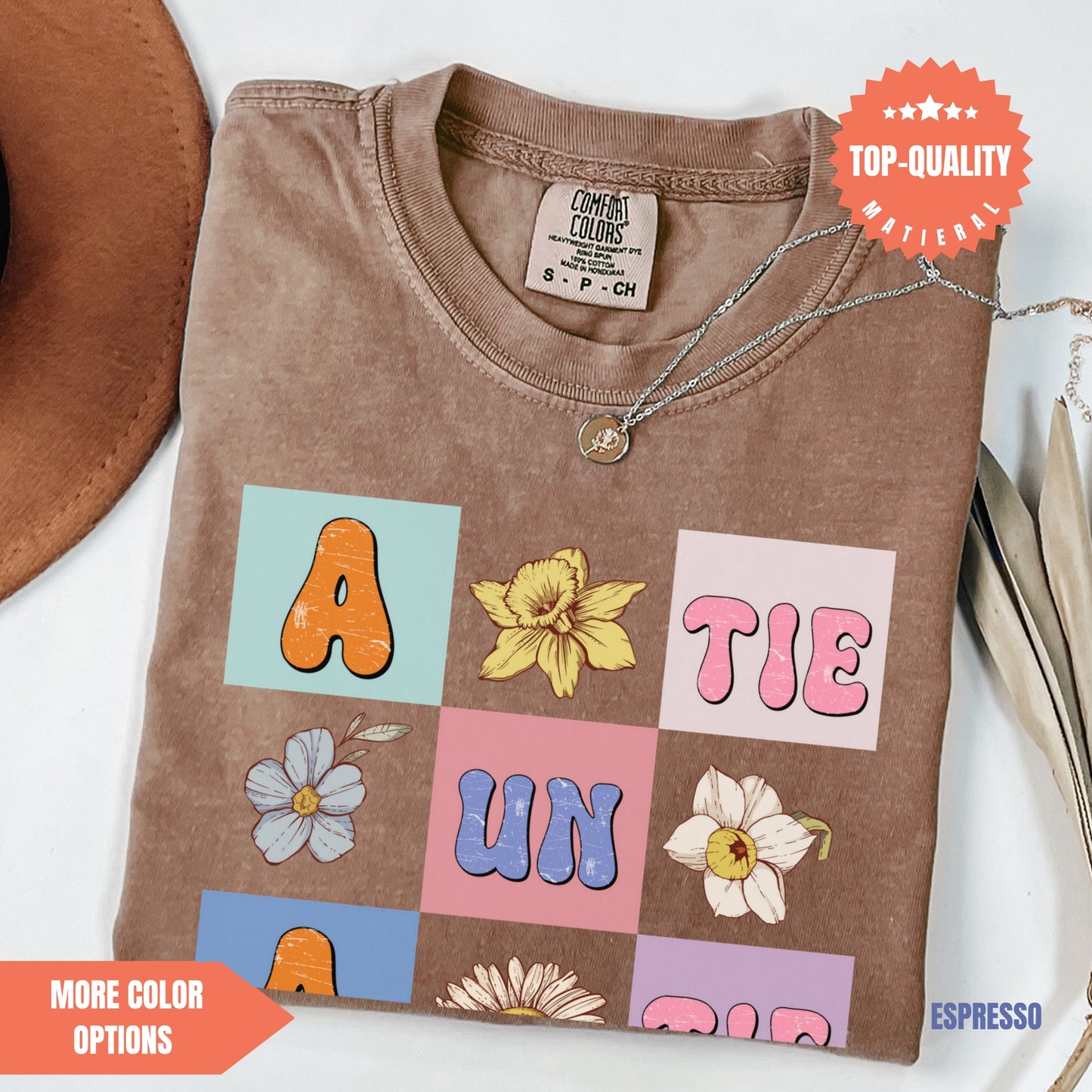a brown t - shirt with letters and flowers on it