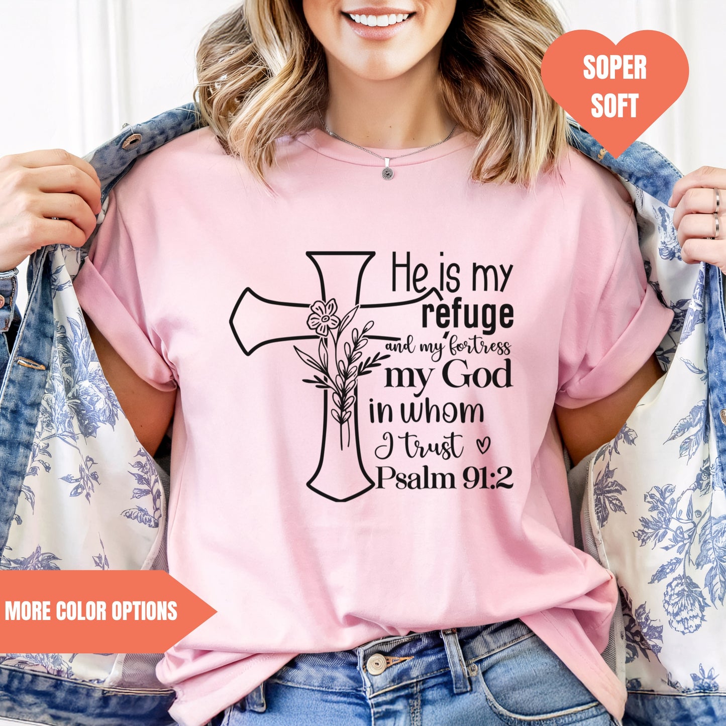 a woman wearing a pink shirt with a cross on it