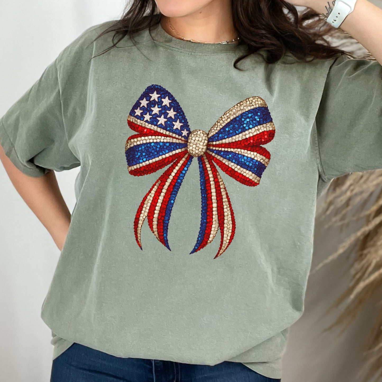 a woman wearing a green shirt with a red, white, and blue bow on