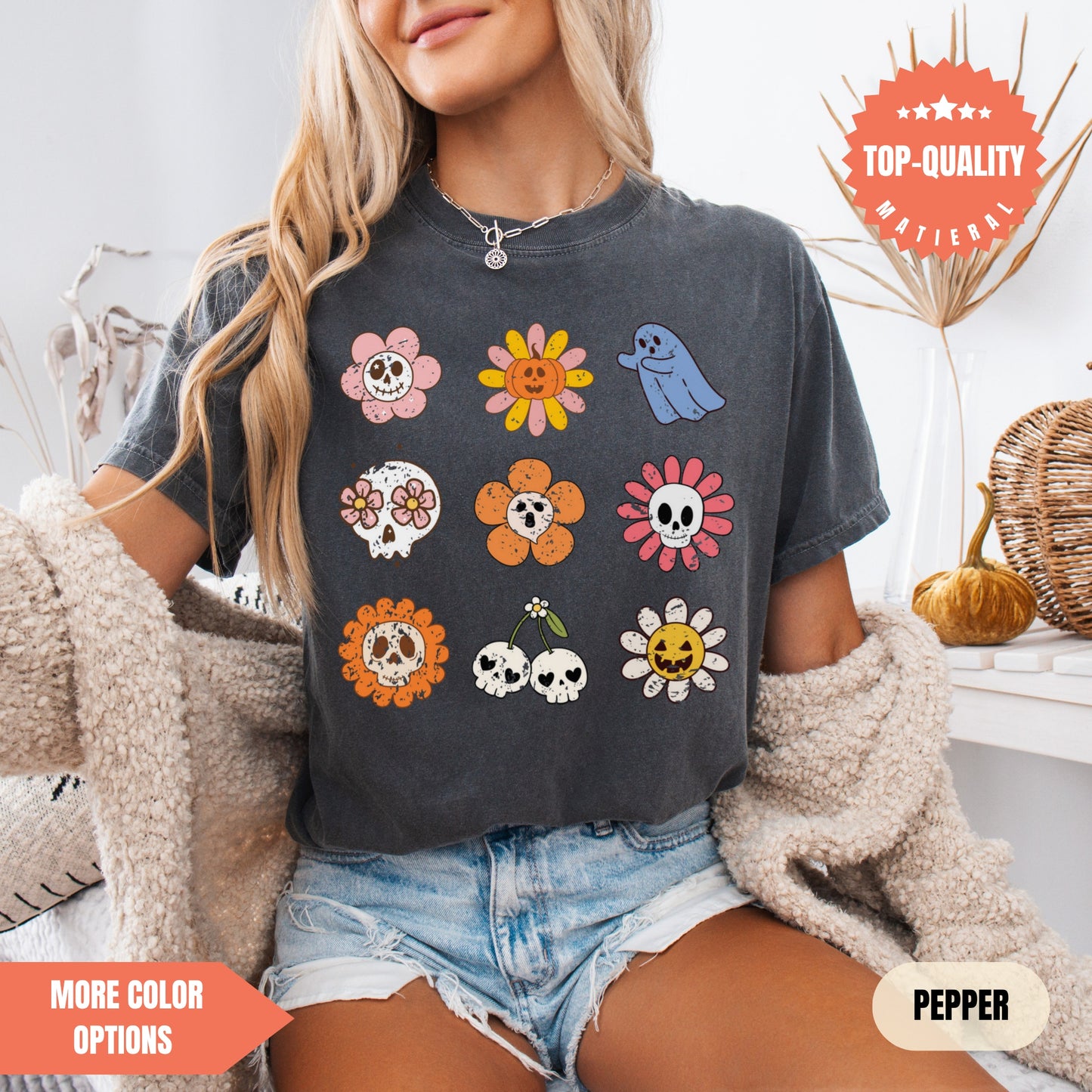 a woman sitting on a bed wearing a black shirt with skulls and flowers on it