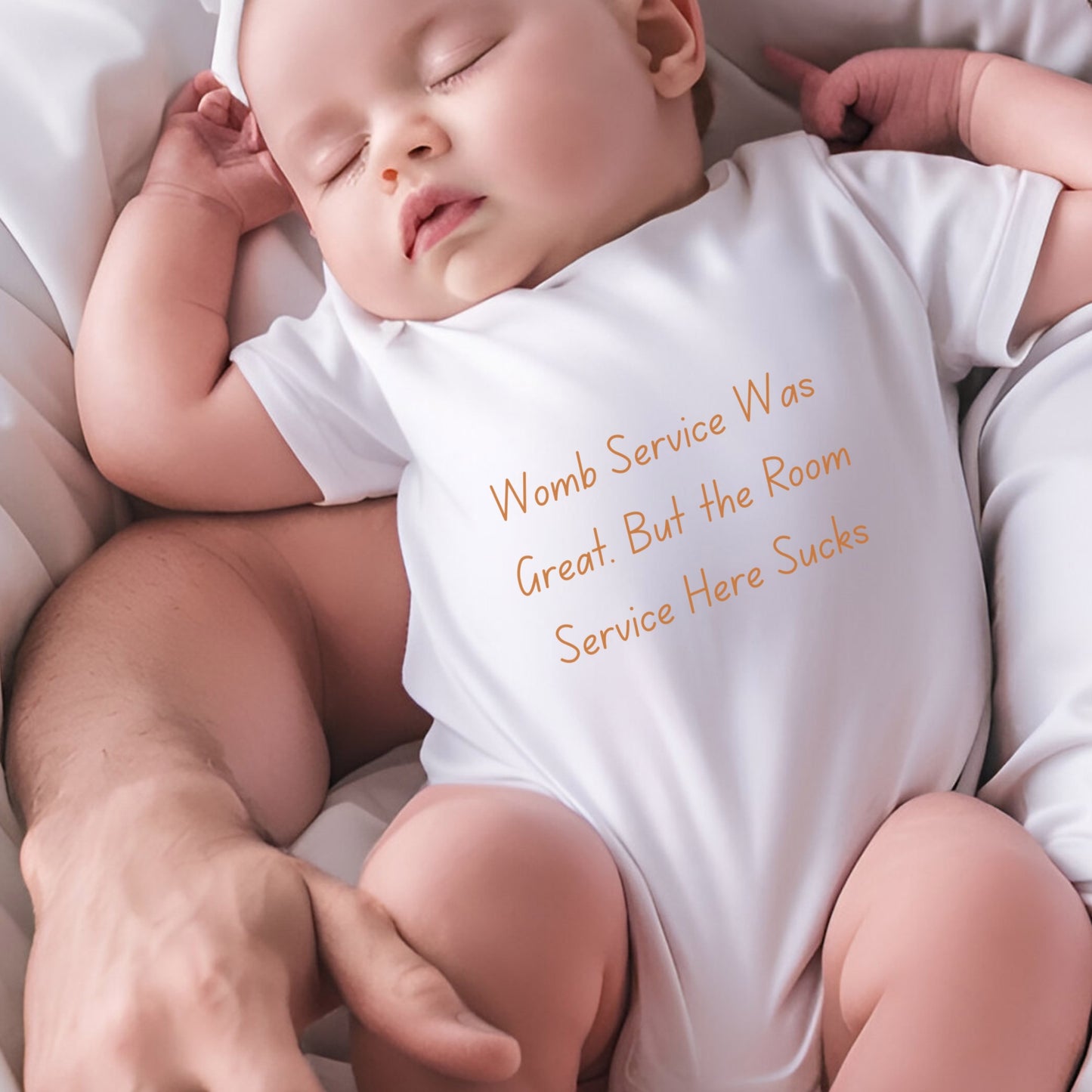 a baby sleeping on a bed with a white shirt