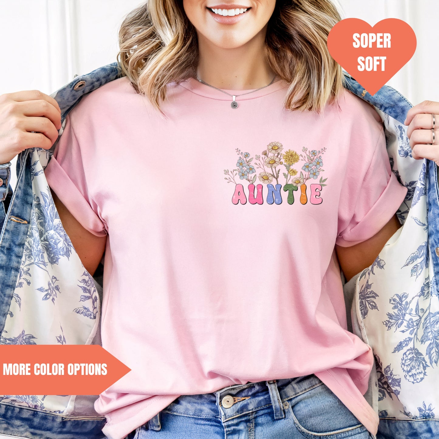 a woman wearing a pink t - shirt with a flower design on it