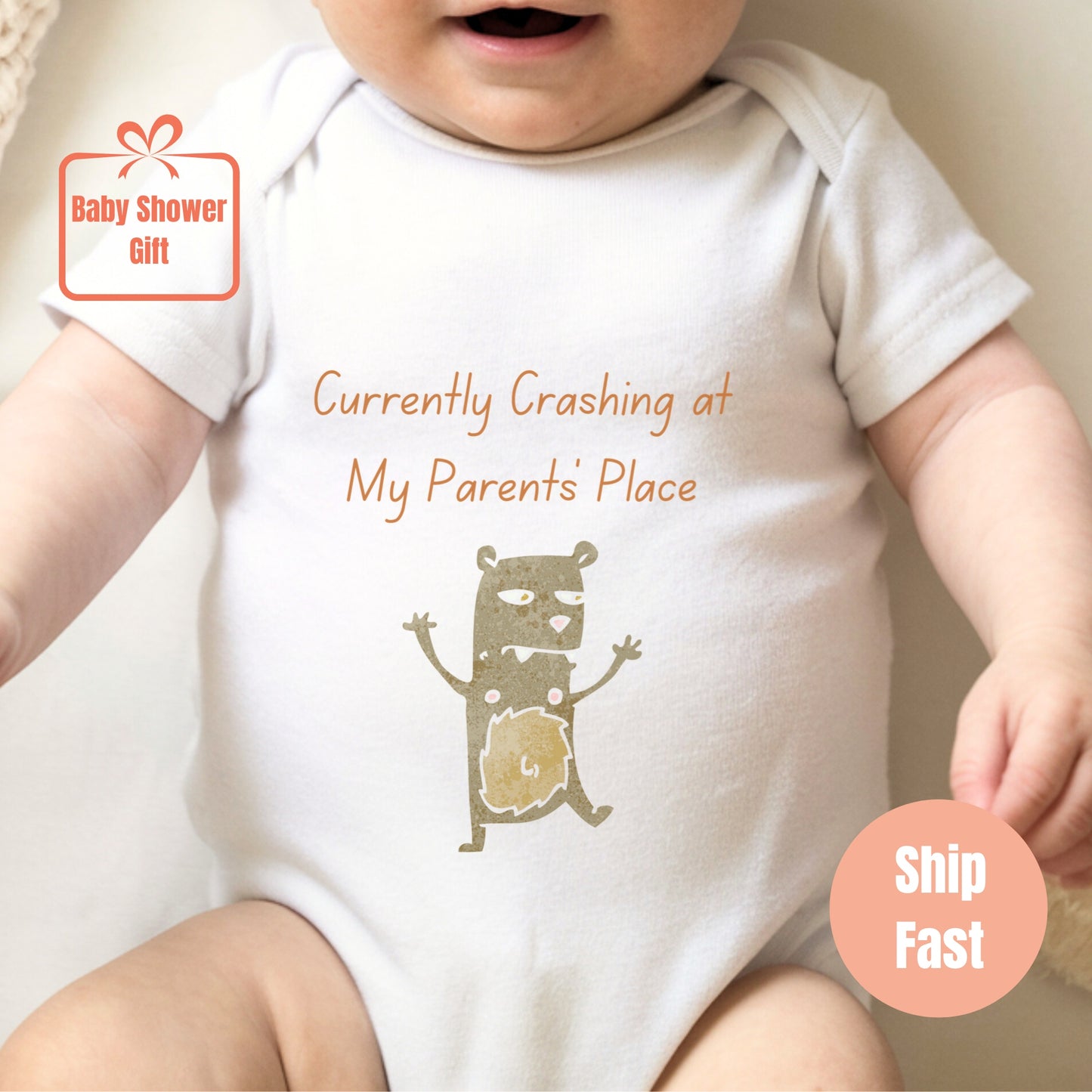 a baby wearing a white shirt with a picture of a cat on it