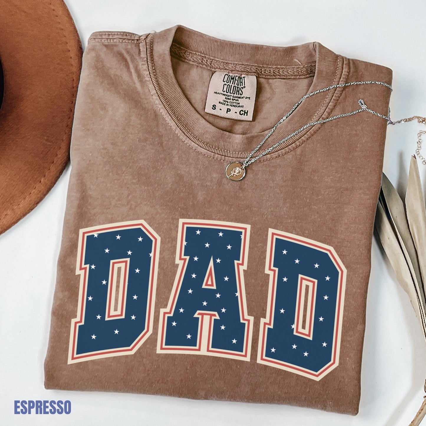 a brown shirt with the word dad on it