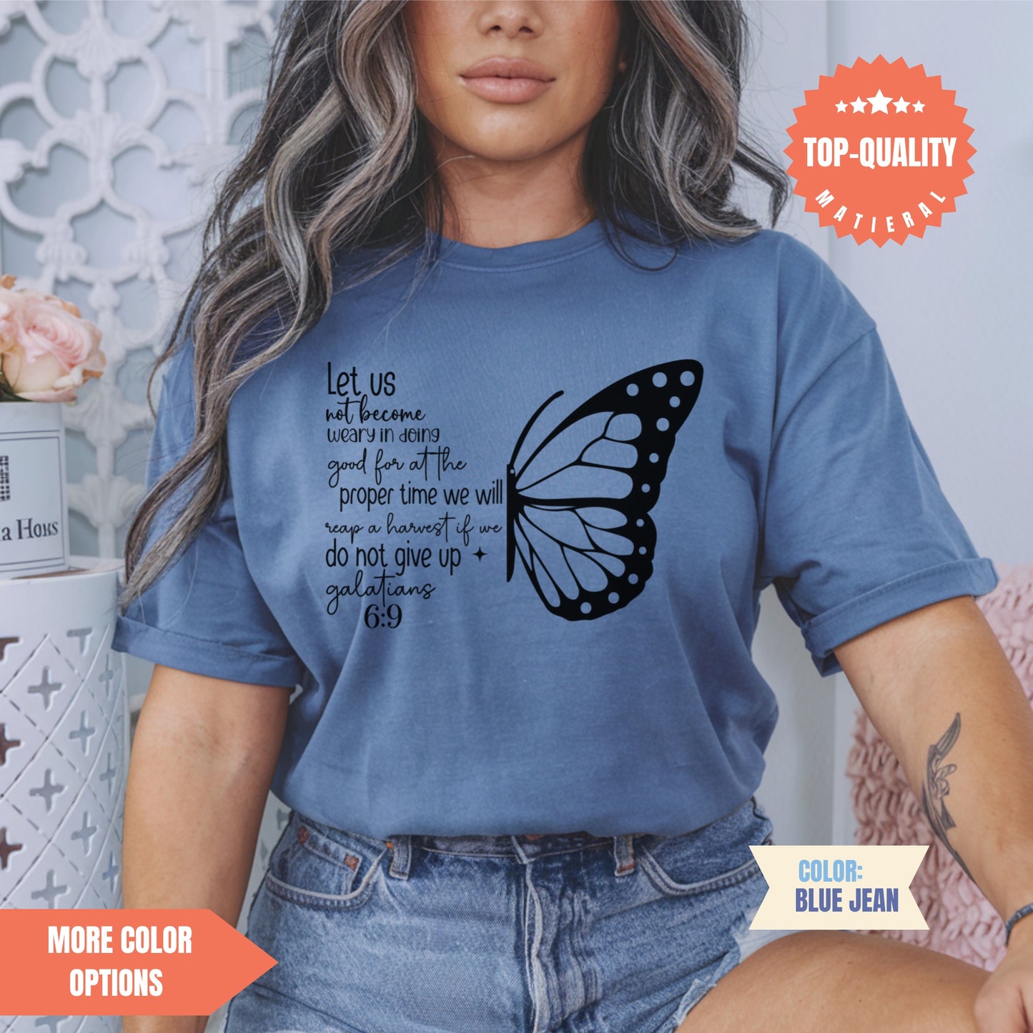 a woman wearing a blue shirt with a butterfly on it