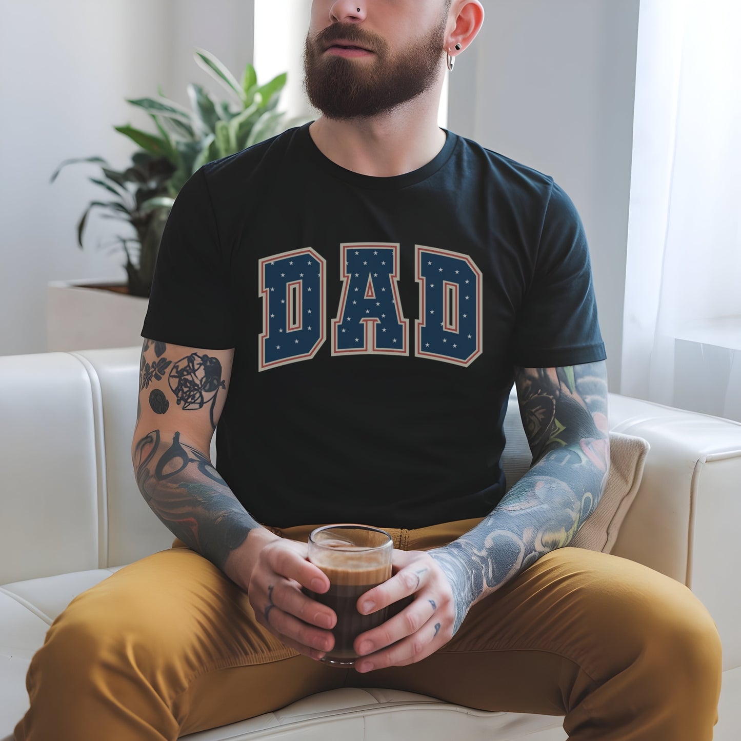 a man with tattoos sitting on a couch holding a cup of coffee