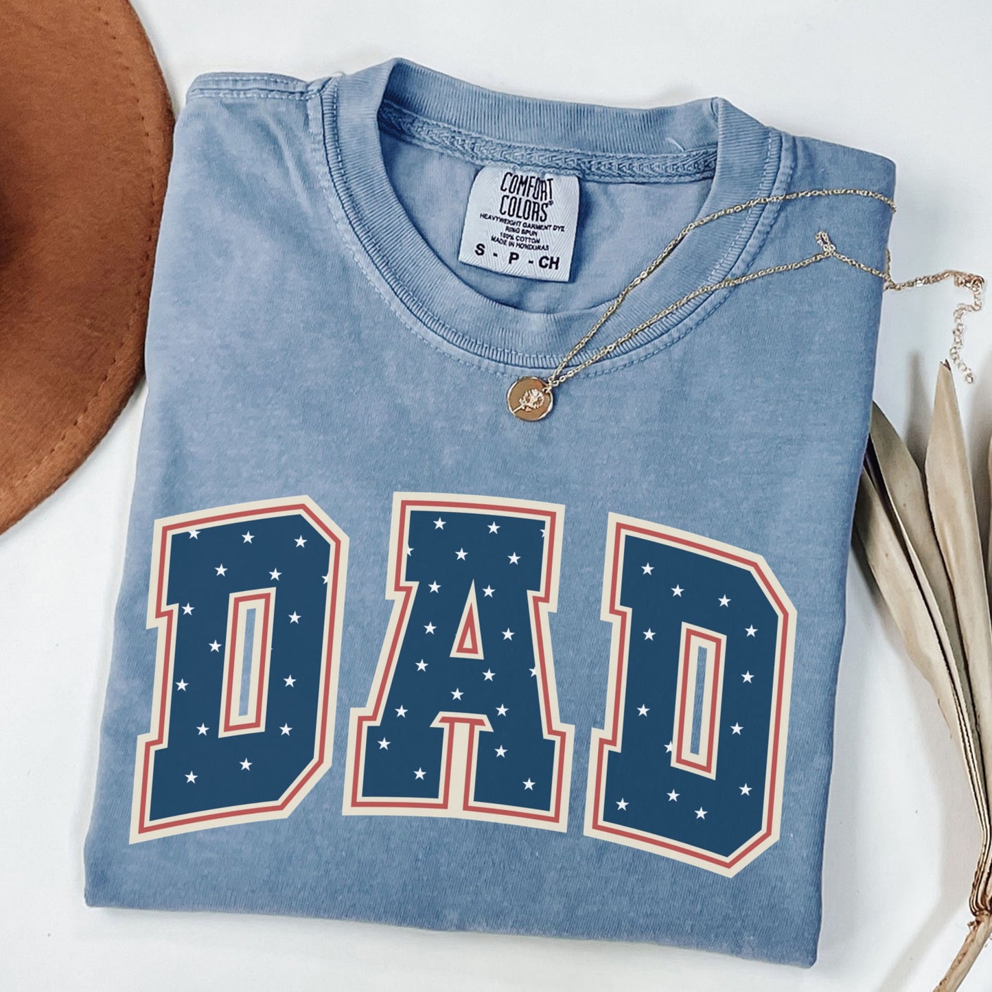 a t - shirt with the word dad on it