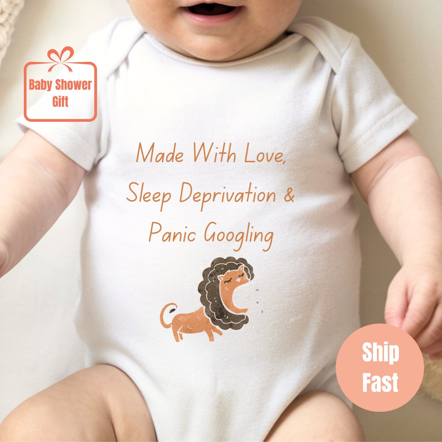 a baby wearing a white bodysuit with a lion on it