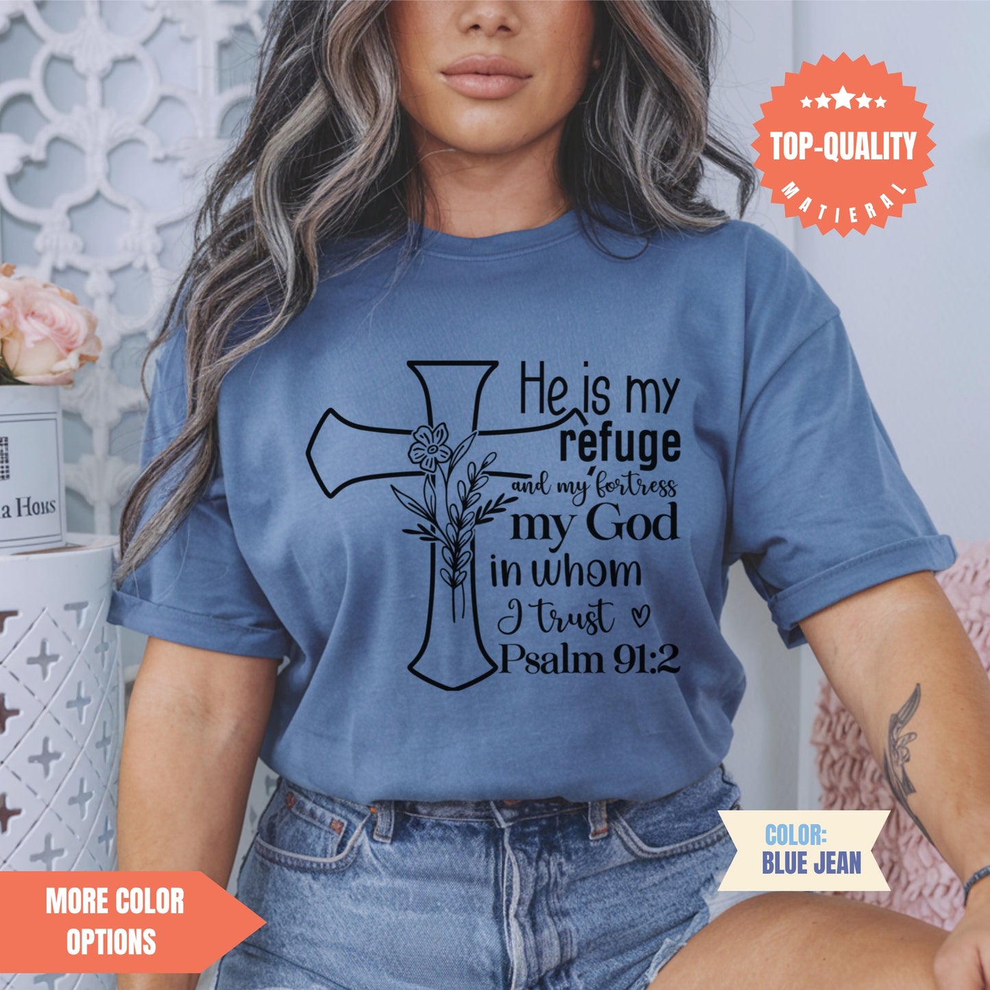 a woman wearing a blue shirt with a cross on it
