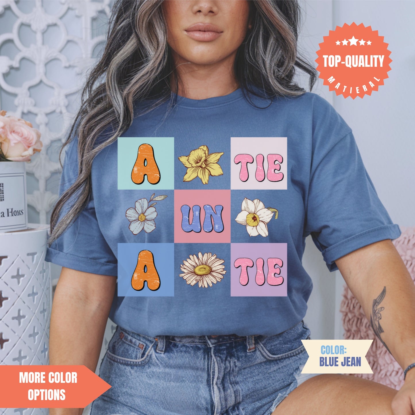 a woman wearing a blue shirt with flowers on it