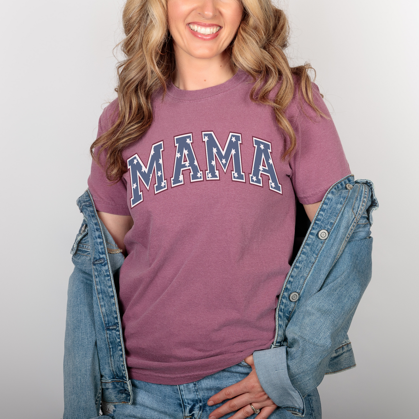 a woman in a maroon shirt and jean jacket