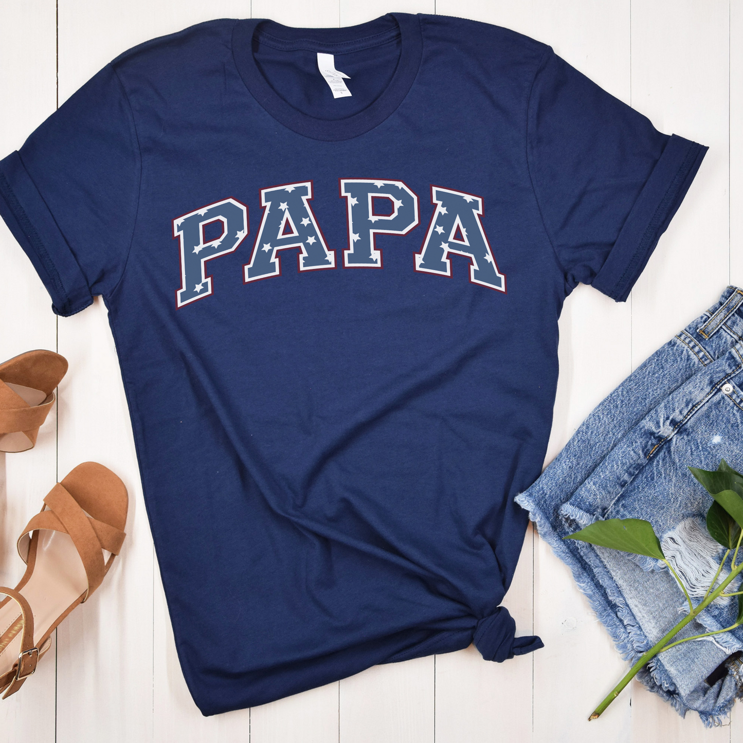 a t - shirt with the word papa on it next to a pair of