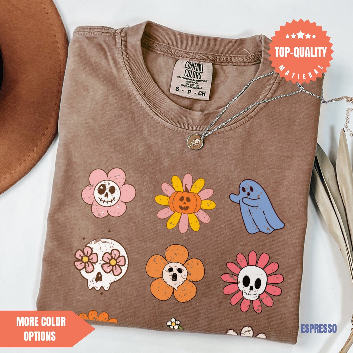 a brown t - shirt with skulls and flowers on it