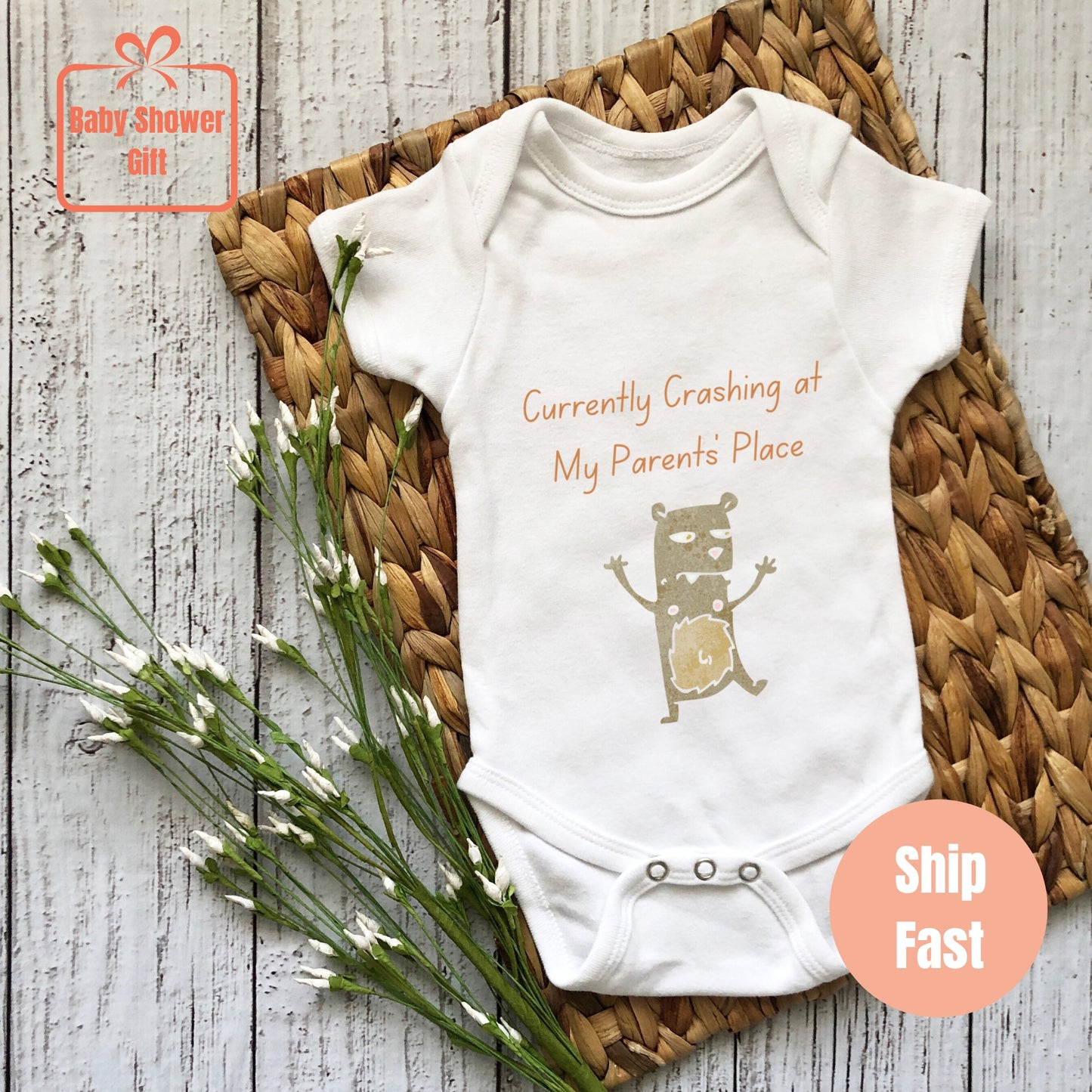 a baby bodysuit with a picture of a bear on it