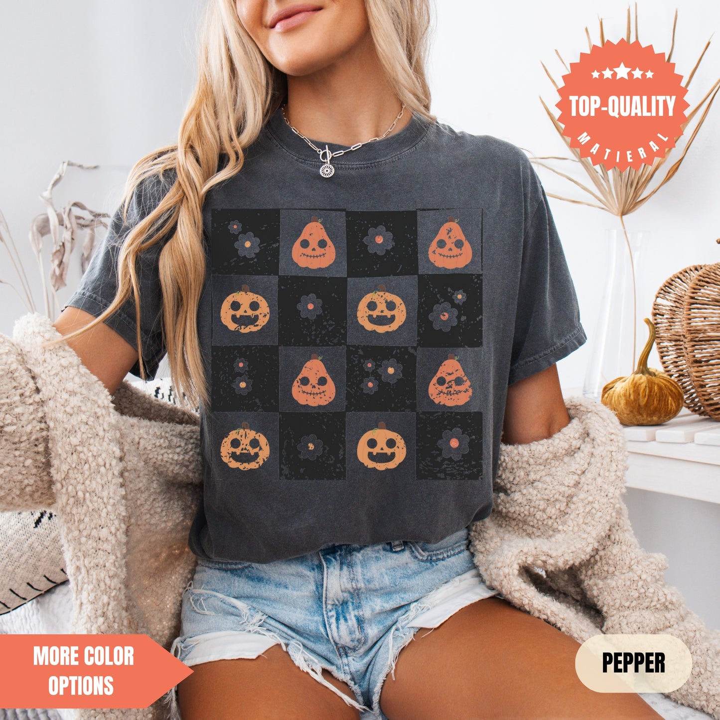 a woman sitting on a bed wearing a t - shirt with pumpkins on it