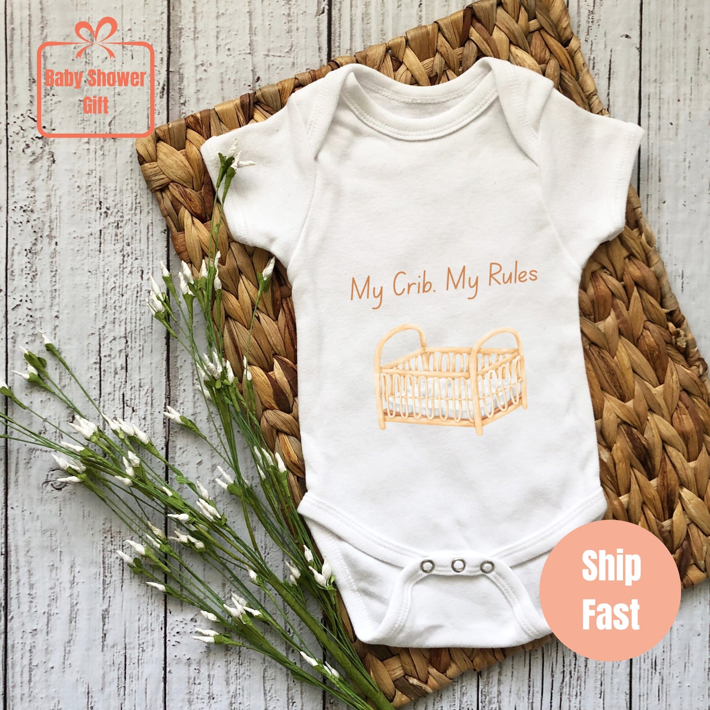 a baby bodysuit with a picture of a crib on it