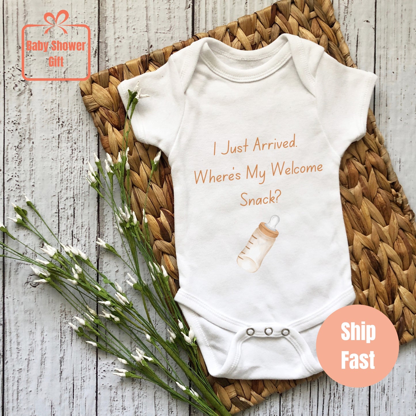 a baby bodysuit that says i just arrived where's my welcome snack?
