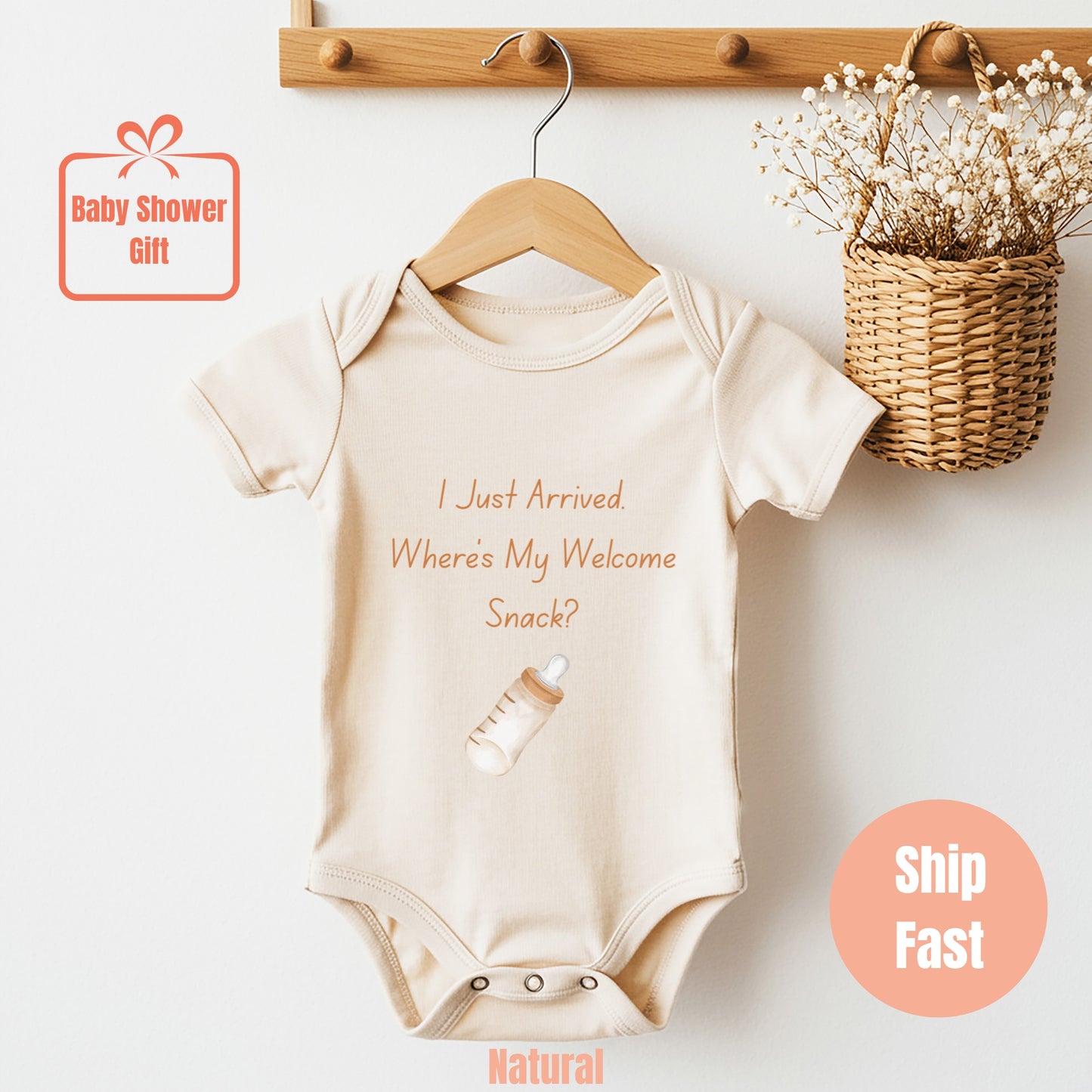 a baby bodysuit hanging on a wooden hanger