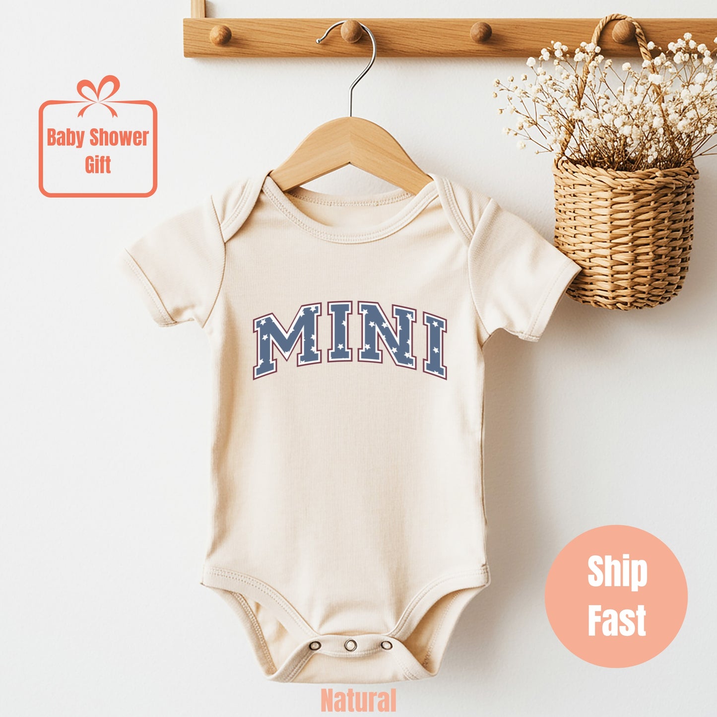 a baby bodysuit hanging on a wooden hanger
