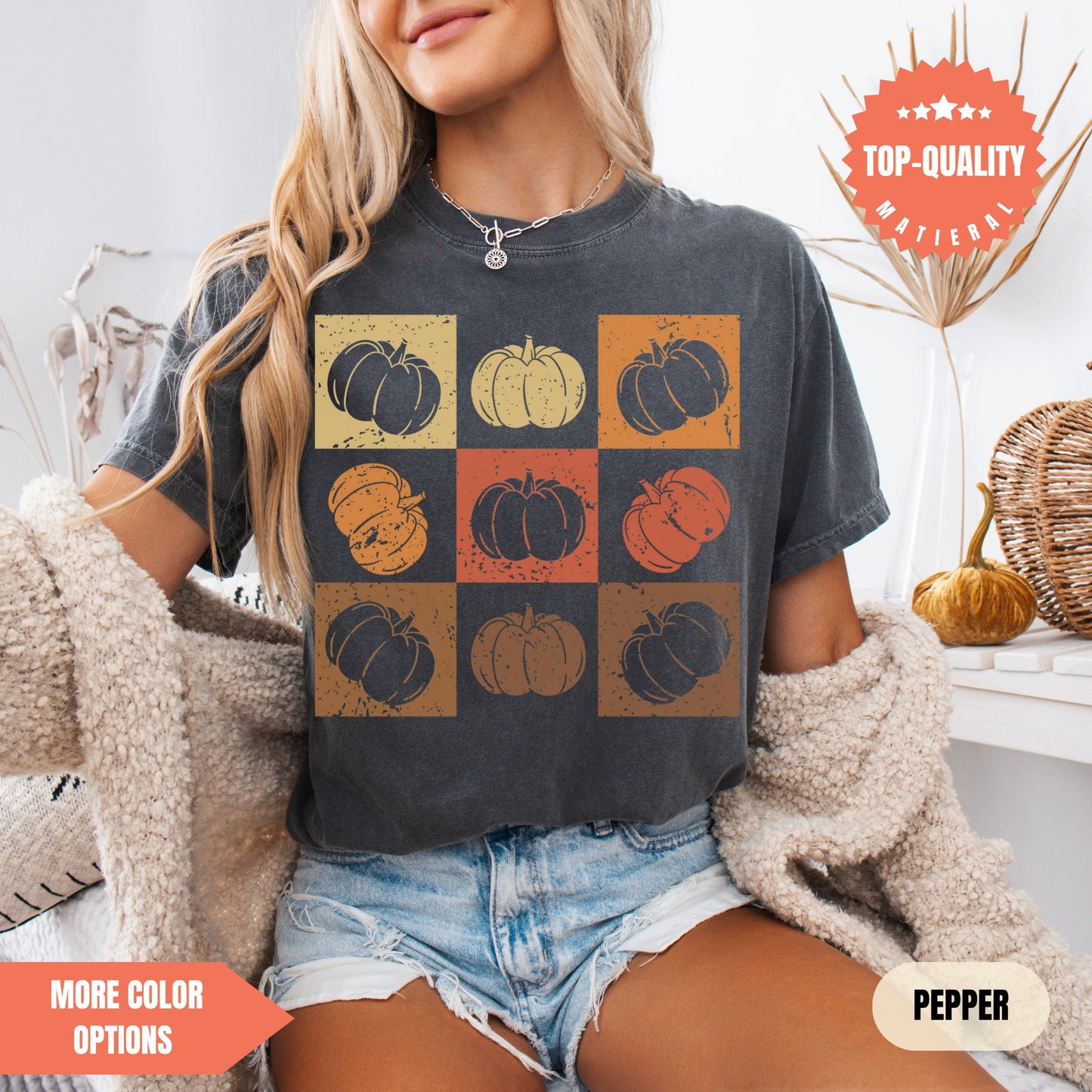 a woman sitting on a bed wearing a t - shirt with pumpkins on it