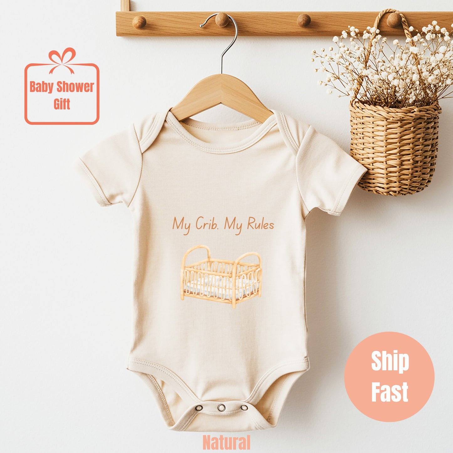 a baby bodysuit hanging on a wooden hanger