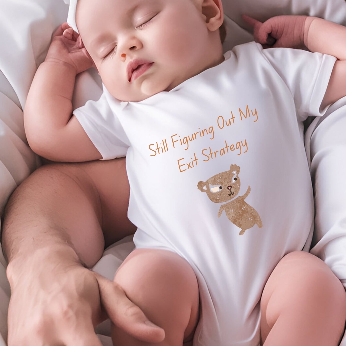 a baby sleeping on a bed wearing a white bodysuit
