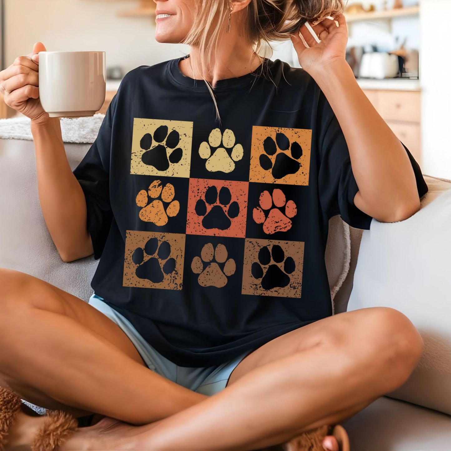 a woman sitting on a couch holding a cup of coffee