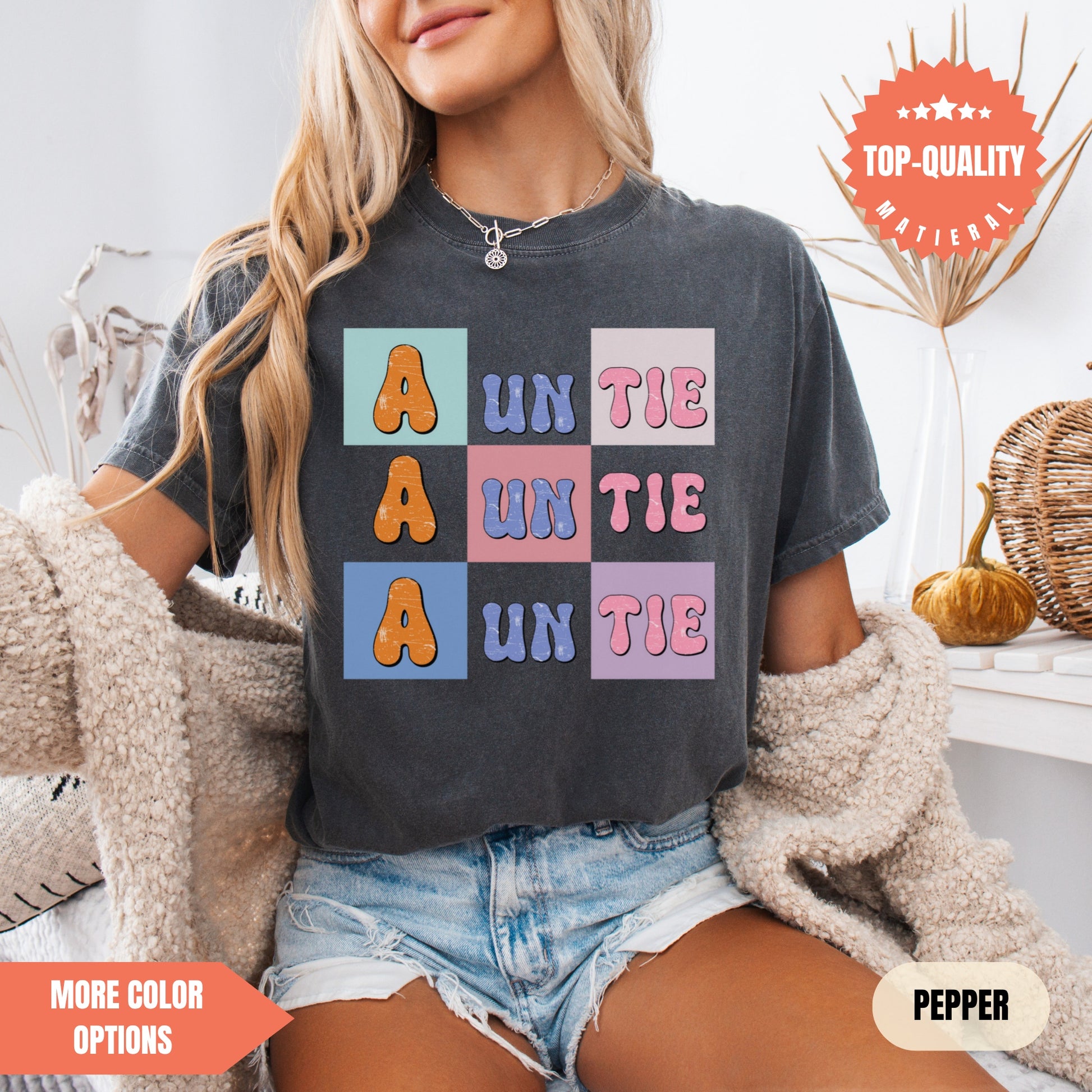 a woman sitting on a bed wearing a t - shirt that says un the a