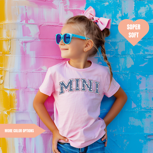 a little girl wearing a pink shirt and sunglasses