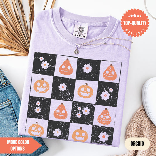 a purple shirt with pumpkins and flowers on it