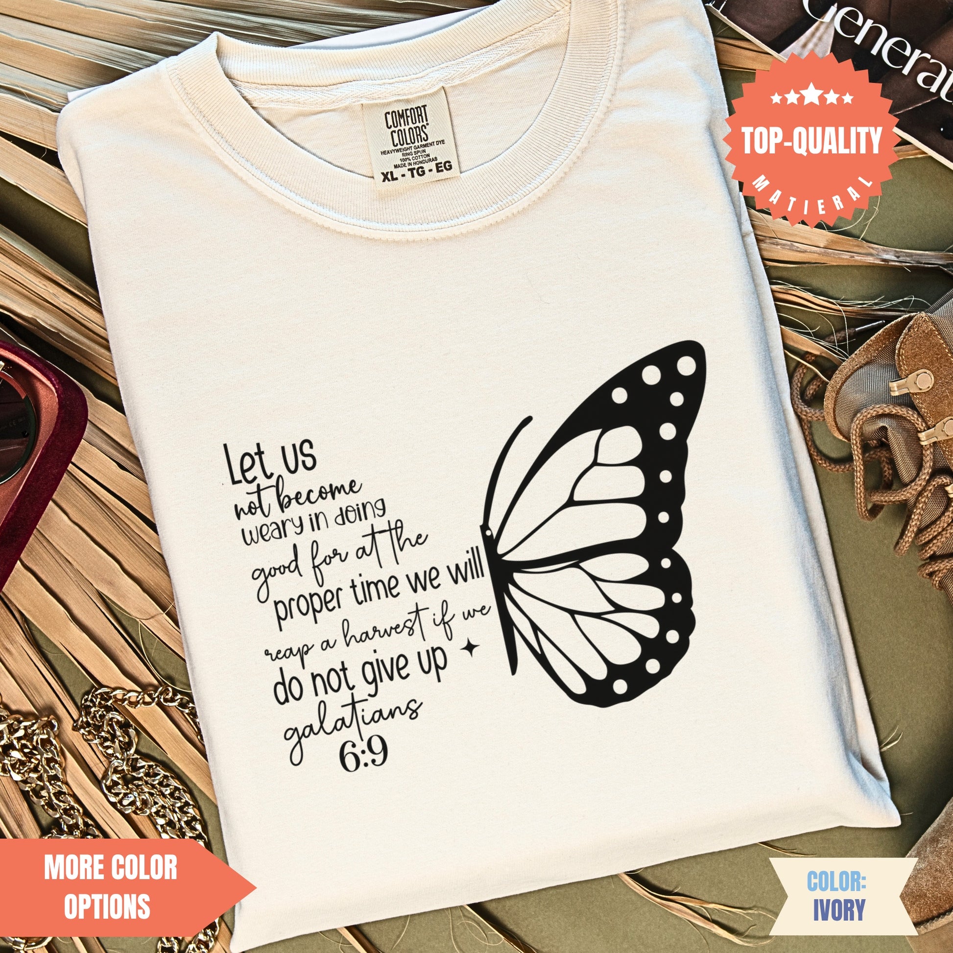 a white t - shirt with a butterfly on it