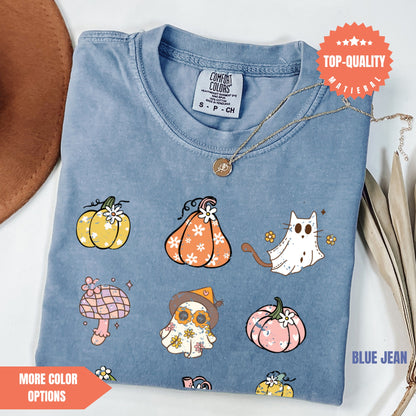 a blue t - shirt with a picture of pumpkins and cats on it