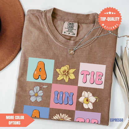 a brown t - shirt with letters and flowers on it