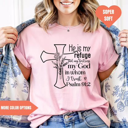 a woman wearing a pink shirt with a cross on it