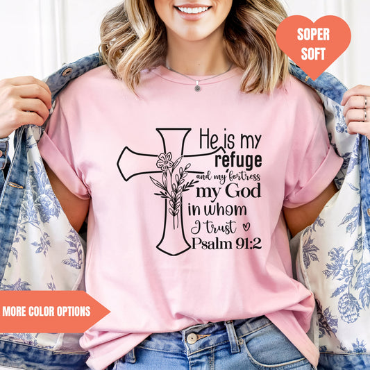 a woman wearing a pink shirt with a cross on it