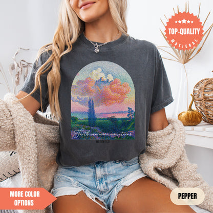 a woman sitting on a bed wearing a t - shirt with a painting of a