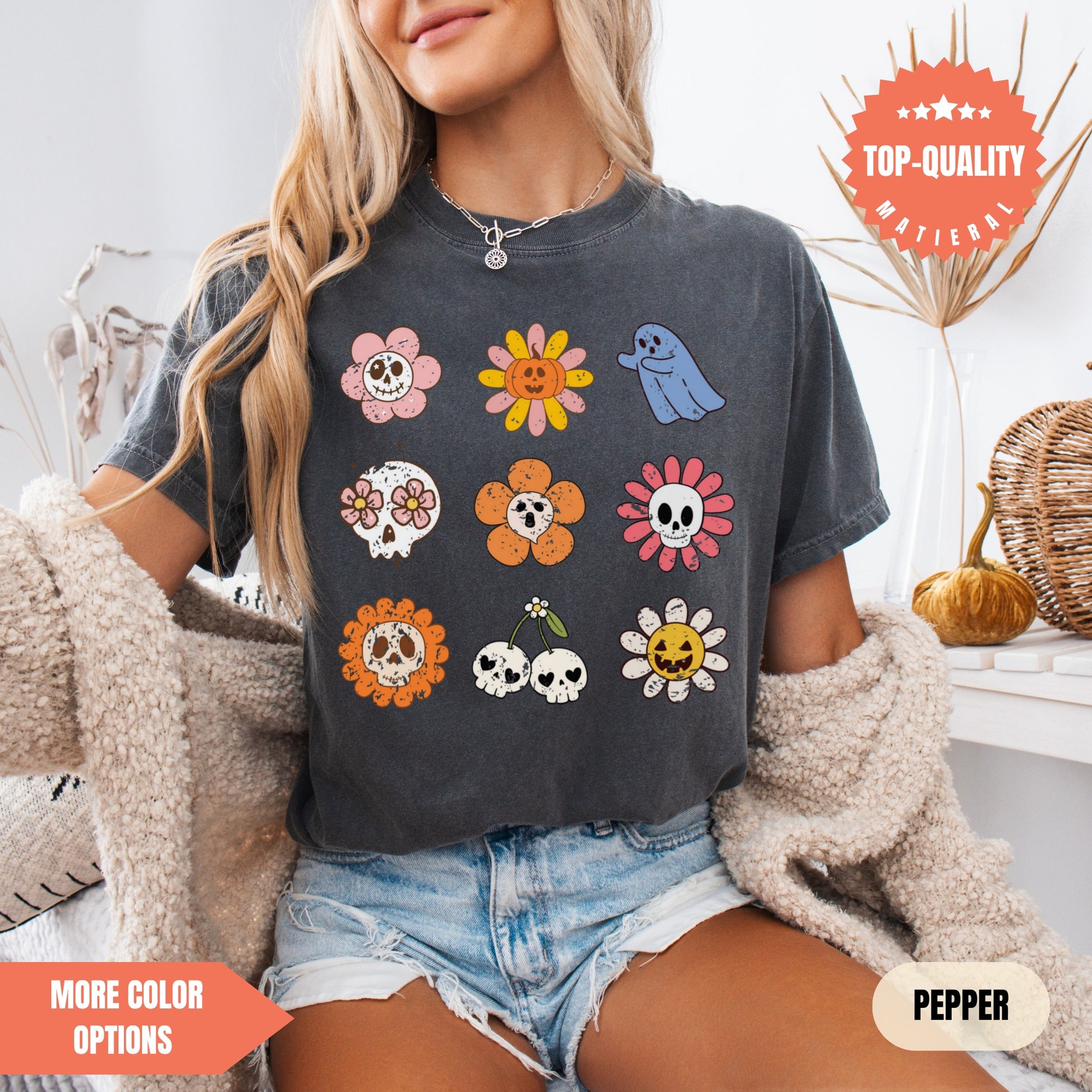 a woman sitting on a bed wearing a black shirt with skulls and flowers on it