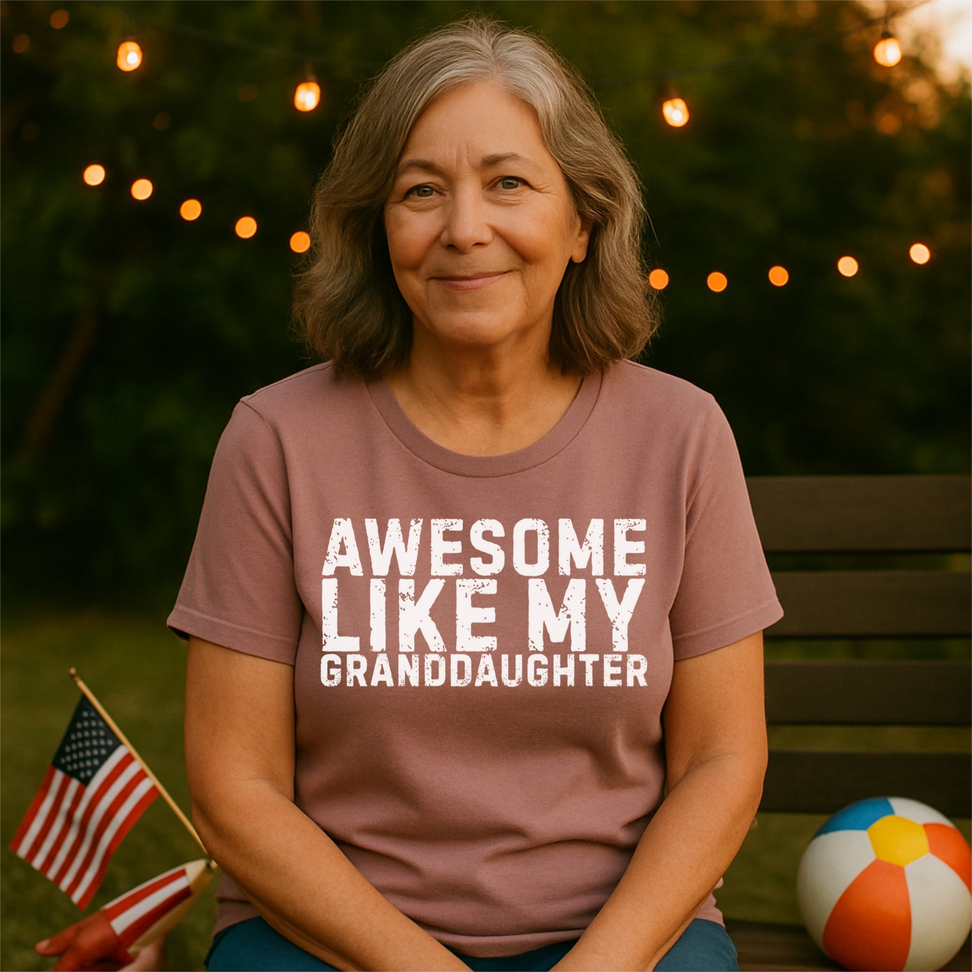 a woman sitting on a bench with an american flag