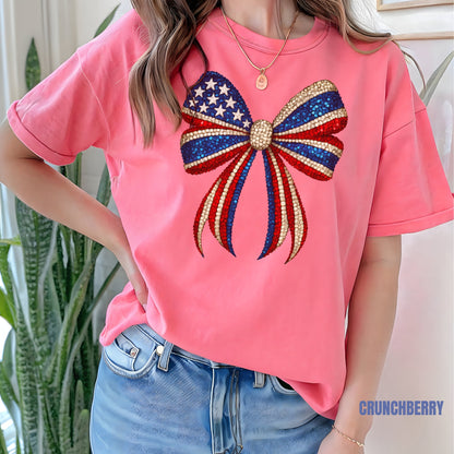 a woman wearing a pink shirt with an american flag bow on it