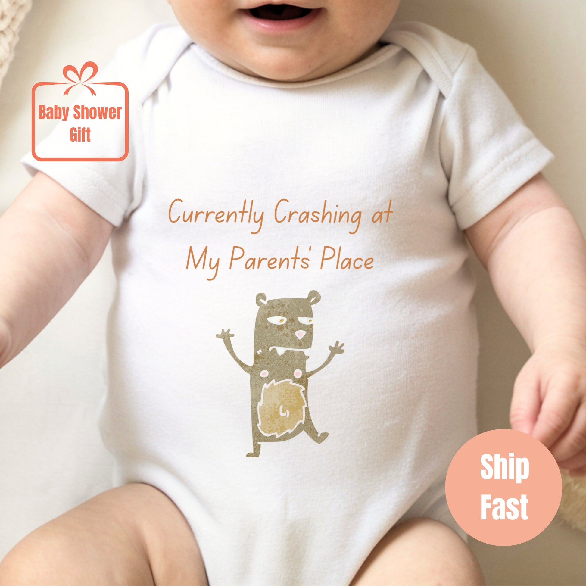 a baby wearing a white shirt with a picture of a cat on it