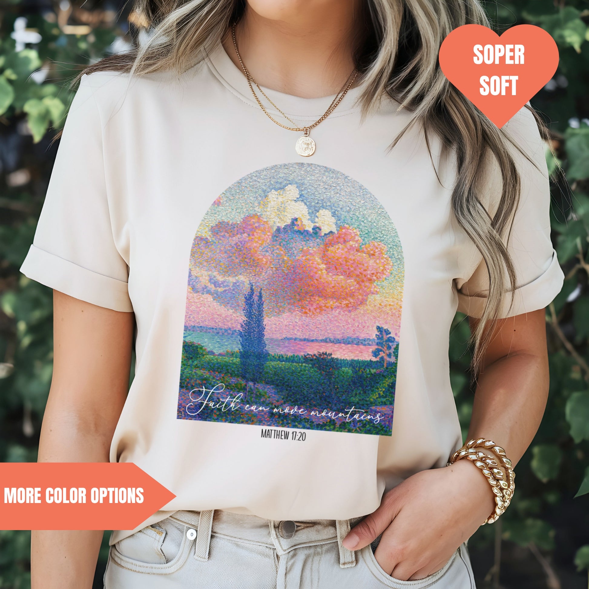 a woman wearing a t - shirt with a painting of a sunset