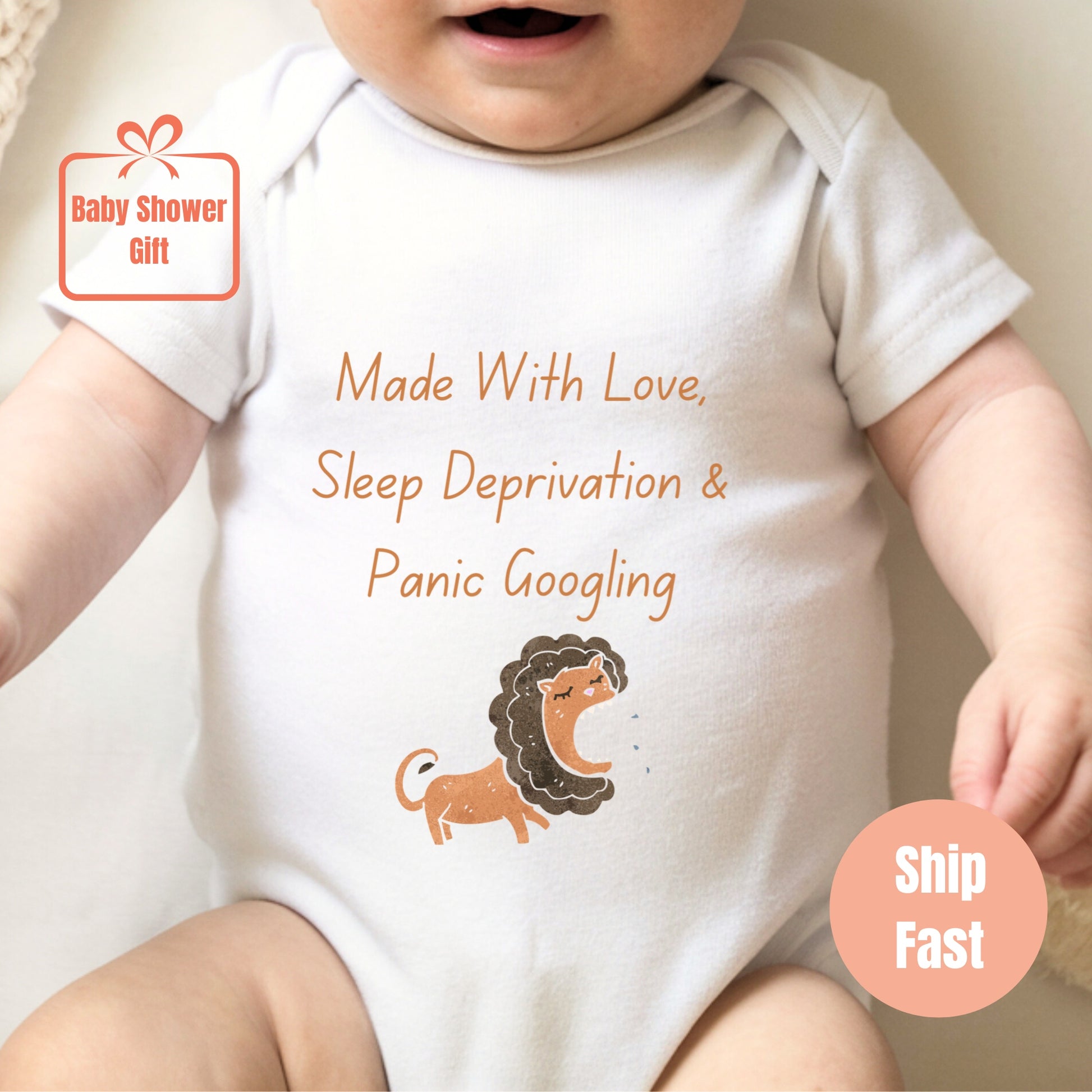 a baby wearing a white bodysuit with a lion on it