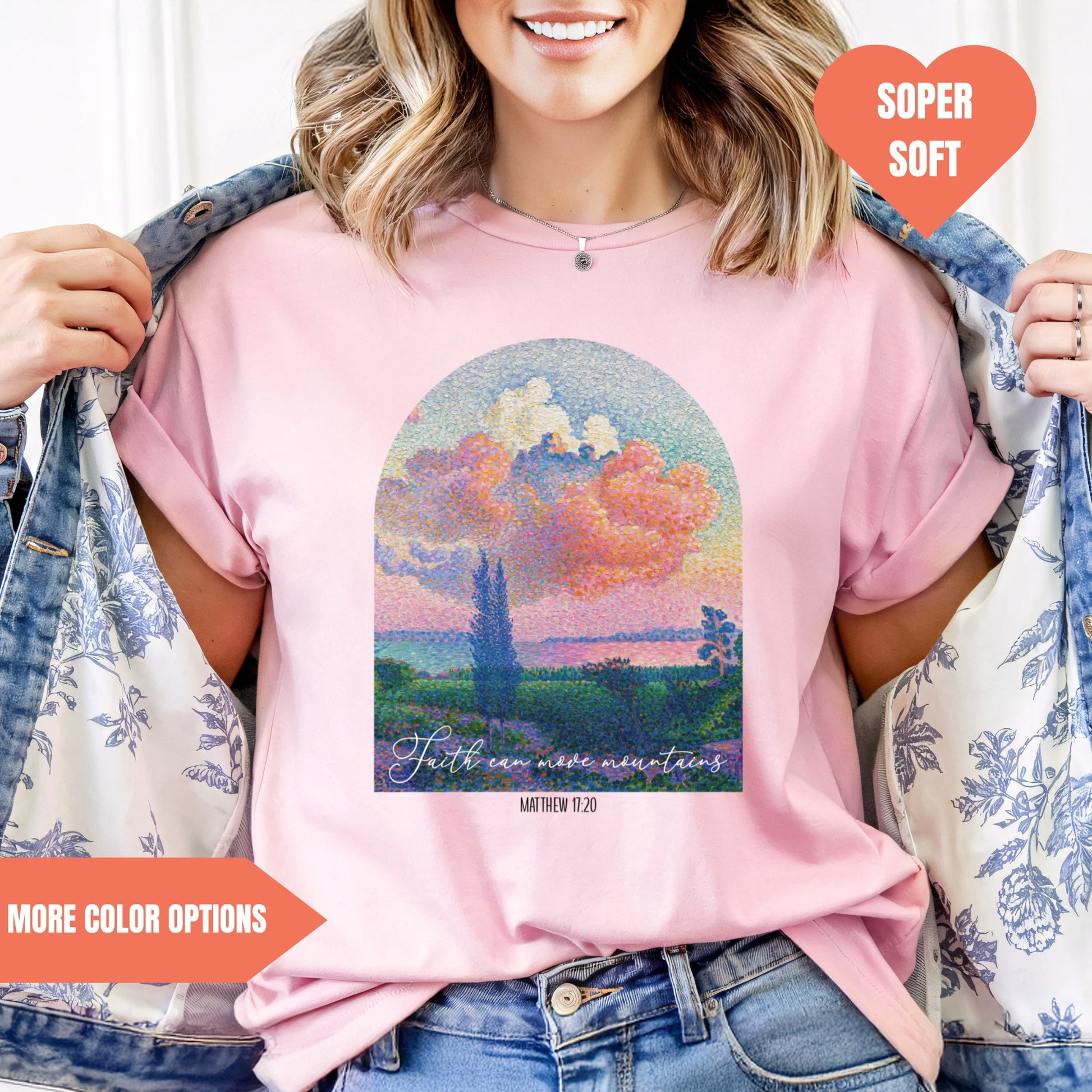 a woman wearing a pink t - shirt with a painting on it