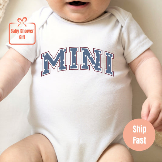 a baby wearing a bodysuit with the word mini on it