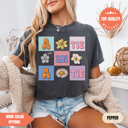 a woman sitting on a bed wearing a t - shirt with flowers on it